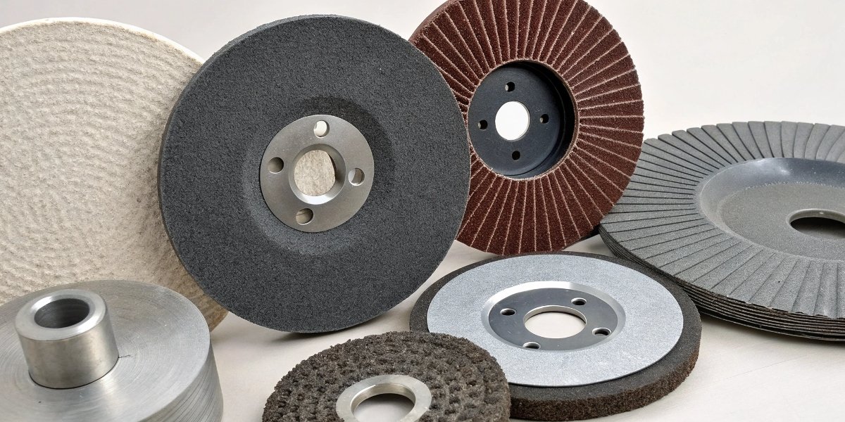 An assortment of different types and shapes of grinding wheels, including cutting discs and thicker wheels.