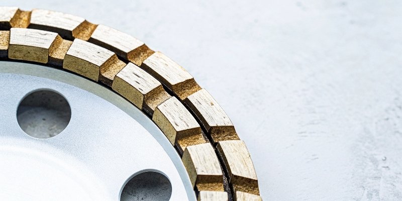 A close-up shot of a diamond cup wheel with its segmented, diamond-impregnated blocks