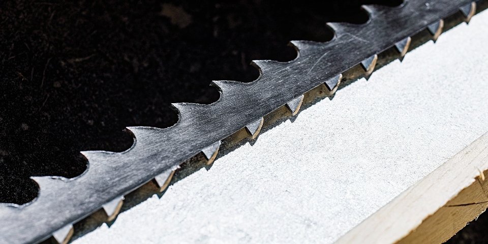 A close-up shot of the rugged carbide teeth on a reciprocating saw blade.
