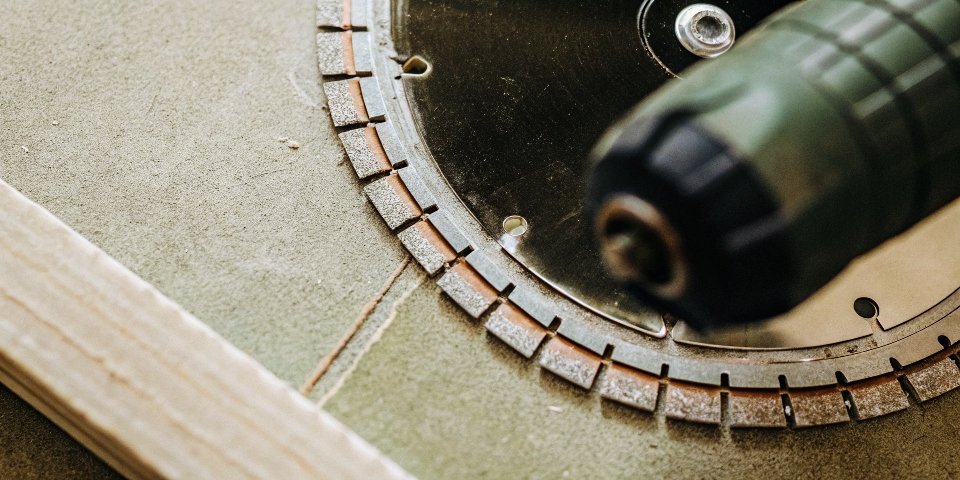 A close-up of a segmented diamond blade mounted on an angle grinder.