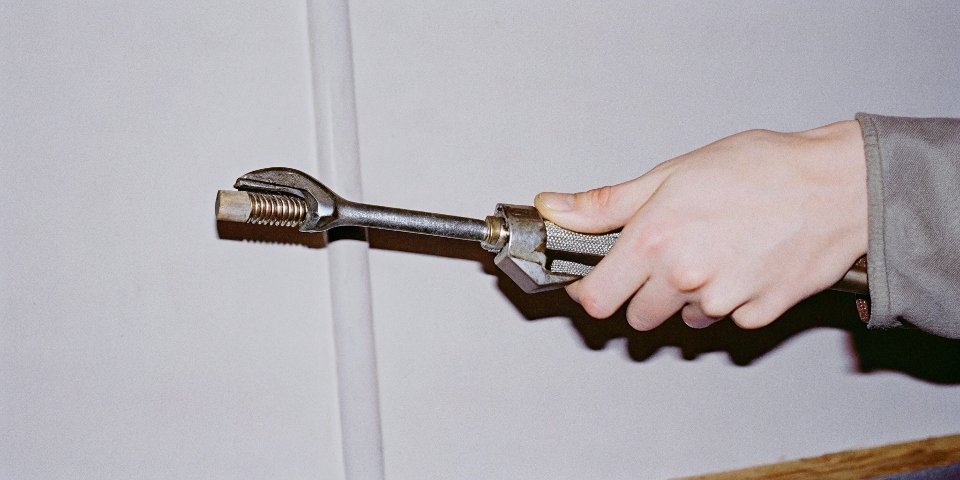 A close-up on a hand using a wrench with a caption indicating 'SNUG TIGHT'.
