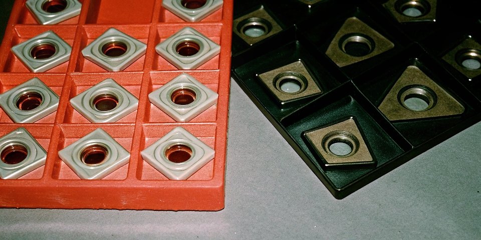 a collection of different carbide inserts with various coatings and grades
