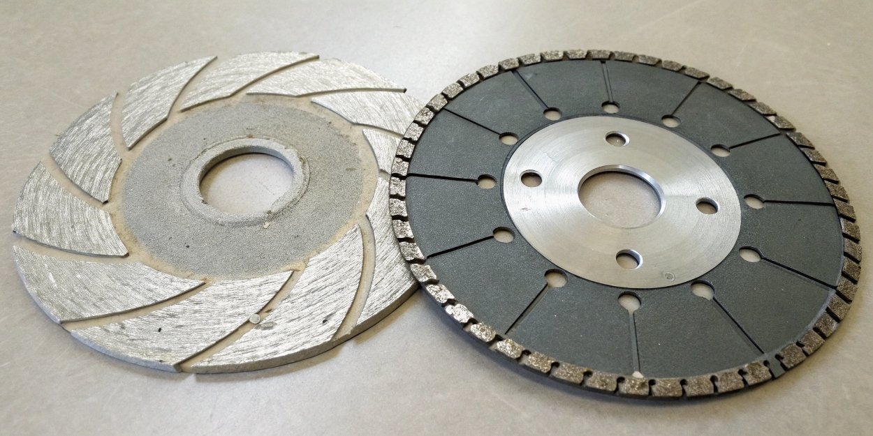 A shattered metal-cutting abrasive disc next to an intact diamond blade.