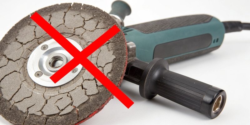 A cracked grinding wheel with a red X over it.